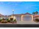 Two-car garage, well-maintained landscaping, and attractive curb appeal at 1613 Shadow Rock Dr, Las Vegas, NV 89117