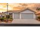 Two-car garage, landscaped yard, and inviting curb appeal at 1613 Shadow Rock Dr, Las Vegas, NV 89117