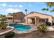 Backyard retreat with a beautiful in-ground pool, outdoor seating area, and lush desert plants at 1704 Nestled Meadows Ln, Las Vegas, NV 89128