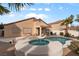 Inviting backyard featuring a sparkling pool, covered patio, and well-maintained desert landscape at 1704 Nestled Meadows Ln, Las Vegas, NV 89128