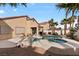 Private backyard oasis featuring a pool, spa, covered patio, and desert landscaping at 1704 Nestled Meadows Ln, Las Vegas, NV 89128