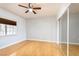 Bright bedroom featuring hardwood floors, a ceiling fan and a mirrored closet at 1830 N Buffalo Dr # 2095, Las Vegas, NV 89128