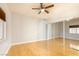 Bright, empty bedroom with laminate floors, ceiling fan, and sliding closet doors at 1830 N Buffalo Dr # 2095, Las Vegas, NV 89128