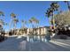 Exterior shot of condo pool with clear blue skies and palm trees at 1830 N Buffalo Dr # 2095, Las Vegas, NV 89128