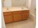 Double vanity bathroom with wood cabinets and tile floors at 2007 Cutlass Dr # 0, Henderson, NV 89014