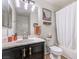 Clean bathroom with dark vanity, tub shower combo, and updated fixtures at 2101 Quartz Cliff St # 207, Las Vegas, NV 89117