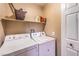 Laundry room with washer, dryer, and additional shelving at 2101 Quartz Cliff St # 207, Las Vegas, NV 89117