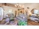 Living room with gray couches, wood floors, and large mirror at 2101 Quartz Cliff St # 207, Las Vegas, NV 89117