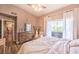 Main bedroom with king-size bed, access to the hallway and light decor at 2101 Quartz Cliff St # 207, Las Vegas, NV 89117