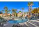 Community pool with palm trees and surrounding landscaping at 2101 Quartz Cliff St # 207, Las Vegas, NV 89117