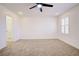 Bright bedroom with ceiling fan, carpet, and access to bathroom at 2120 Waterlily View St, Henderson, NV 89044