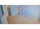 Light blue bedroom with beige carpet, closet, and access to hallway at 2451 N Rainbow Blvd # 2144, Las Vegas, NV 89108