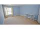 Light blue bedroom with beige carpet, window, and built-in desk at 2451 N Rainbow Blvd # 2144, Las Vegas, NV 89108