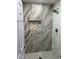 Updated bathroom with a large walk-in shower and marble-look tile at 2620 Silverton Dr, Las Vegas, NV 89134