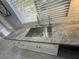 Kitchen with a large stainless steel sink and granite countertop at 2620 Silverton Dr, Las Vegas, NV 89134