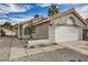 Charming single-story home featuring a two-car garage, desert landscaping, and a tile roof at 2668 Alwoodley Cir, Las Vegas, NV 89142