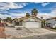 Charming single-story home featuring a two-car garage, desert landscaping, and a tile roof at 2668 Alwoodley Cir, Las Vegas, NV 89142