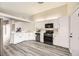 Bright kitchen featuring white cabinets, stainless steel appliances, and light wood flooring at 2668 Alwoodley Cir, Las Vegas, NV 89142