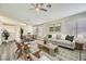 Bright living room featuring contemporary furnishings, neutral paint, light wood flooring, and bright natural light at 2668 Alwoodley Cir, Las Vegas, NV 89142