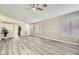 Bright living room featuring neutral paint, light wood flooring, bright natural light and a ceiling fan at 2668 Alwoodley Cir, Las Vegas, NV 89142