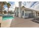 Outdoor pool with a tile roof home and desert landscaping at 2668 Alwoodley Cir, Las Vegas, NV 89142