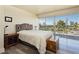 Main bedroom with plush bed, hardwood floors and city view at 3111 Bel Air Dr # 4G, Las Vegas, NV 89109