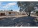 Large backyard with covered patio and mature tree at 3883 Seedling Way, Las Vegas, NV 89115