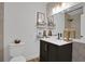 Elegant bathroom with dark vanity, geometric wallpaper, and modern fixtures at 3883 Seedling Way, Las Vegas, NV 89115