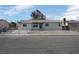 Single-story home with a fenced front yard and neutral color scheme at 3883 Seedling Way, Las Vegas, NV 89115