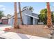 Gray house with palm trees and a landscaped yard at 4775 Summerhill Rd, Las Vegas, NV 89121