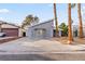 Gray house with palm trees and a paved driveway at 4775 Summerhill Rd, Las Vegas, NV 89121