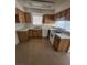 Galley kitchen with wood cabinets and tile flooring at 4801 Fiesta Lakes St, Las Vegas, NV 89130