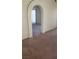 View of living room with arched entryway and neutral carpeting at 4801 Fiesta Lakes St, Las Vegas, NV 89130