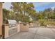 Outdoor kitchen with built-in grill and stone countertops at 5124 Pensier St, Las Vegas, NV 89135