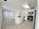 Modern white kitchen with stainless steel appliances and an island at 5222 Mandalay Springs Dr # 202, Las Vegas, NV 89120