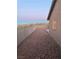 Gravel backyard with block wall and partial view of highway at 609 W Victory Rd, Henderson, NV 89015