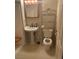 Bathroom with pedestal sink, toilet and storage shelving at 609 W Victory Rd, Henderson, NV 89015