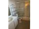 Bathroom with tub, toilet, vanity, and storage shelving at 609 W Victory Rd, Henderson, NV 89015