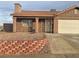 Tan colored stucco house with a two-car garage at 609 W Victory Rd, Henderson, NV 89015