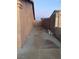 Long side yard with cement slab and gated access at 609 W Victory Rd, Henderson, NV 89015