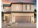 Two-story house with a beige exterior, two-car garage, and landscaping at 6130 Yuzu Pl, Las Vegas, NV 89122