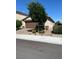 House exterior with a brown garage door and a tree in front at 6306 Orions Belt Peak St, North Las Vegas, NV 89031