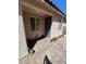 Front entry with gray door, tile flooring, and potted plants at 6306 Orions Belt Peak St, North Las Vegas, NV 89031