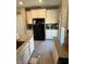 Well-equipped kitchen featuring granite countertops and black appliances at 6306 Orions Belt Peak St, North Las Vegas, NV 89031