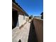 Side yard with brick pathway, cacti, and a gate at 6306 Orions Belt Peak St, North Las Vegas, NV 89031