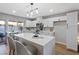 Modern kitchen with white cabinets, quartz countertops, and island at 7134 Grasswood Dr, Las Vegas, NV 89147