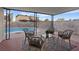 Covered patio with seating area overlooking the pool at 7134 Grasswood Dr, Las Vegas, NV 89147