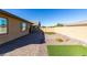 Home's backyard features a paved patio, artificial turf, and desert landscaping at 752 Drammatico Pl, Henderson, NV 89011