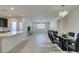 Open concept dining room with a glass table and chandelier at 752 Drammatico Pl, Henderson, NV 89011