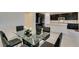 Dining area with glass table and black chairs near kitchen at 752 Drammatico Pl, Henderson, NV 89011